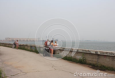 Russia, Novosibirsk, July 21, 2019: a man and a woman stand hugging on the seafront near the hydroelectric dam on a summer day Editorial Stock Photo