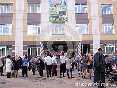 Russia, Novosibirsk, September 1, 2012: a large crowd of parents and first-graders near the school came to classes with students Editorial Stock Photo