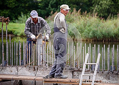 Russia Petersburg August 4, 2020: road Workers perform road and bridge repairs in the city. Editorial Stock Photo