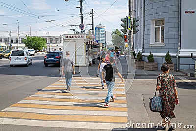 Russia, Rostov on Don, June 28, 2018: People cross the road to a red traffic light. Violation of traffic rules. Danger to life. Editorial Stock Photo