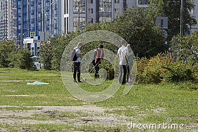 Russia, Saint-Petersburg, July 2019: Volunteers collecting garbage in park and street in town. Ecology group Editorial Stock Photo