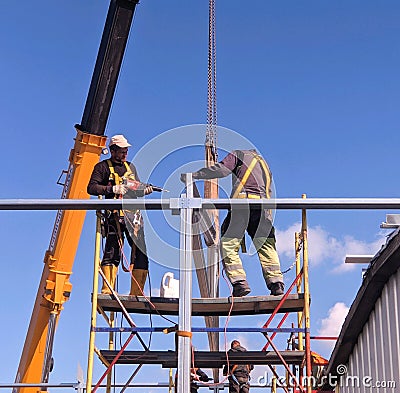 RUSSIA, SAINT PETERSBURG - JULY 10, 2022: The work of builders on the erection of a frame from metal structures Editorial Stock Photo