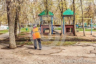 Cleaning lady sweeping a park Editorial Stock Photo