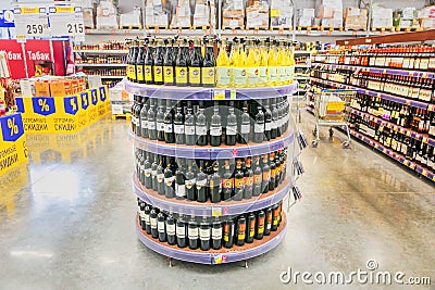 a large selection of various wines are on the shelf in a large supermarket. Editorial Stock Photo