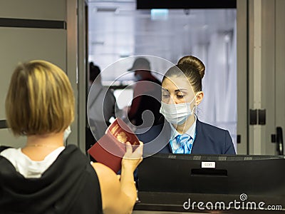 Russia, Sochi 02.11.2021. An airport worker checks passengers' documents and lets them board the plane Editorial Stock Photo