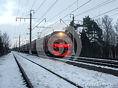 Russia, St. PetersburElectric train following the railroad in winter Editorial Stock Photo