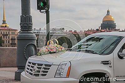 Russia, St. Petersburg, city streets, road transport, wedding car close-up, in the background the golden dome of St. Isaac`s Cathe Stock Photo