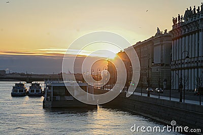 Russia, St. Petersburg, The delightful golden sun, the sun`s rays over the Neva River. View of the Palace embankment and the sight Editorial Stock Photo