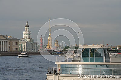 Russia, St. Petersburg, the embankment of the river in summer, tourist boats, the spire of the Peter and Paul Fortress in the back Editorial Stock Photo