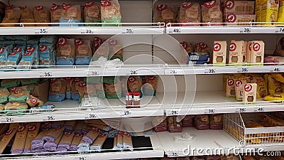 Half-empty shelves with pasta due to coronovirus in a supermarket Editorial Stock Photo