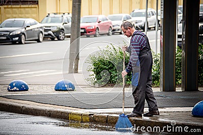 Russia, St. Petersburg, July 31, 2020: a street sweeper sweeps the streets of the city. Editorial Stock Photo