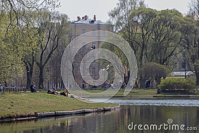 Russia, St. Petersburg, vacationers in the park, early summer, sunny day Editorial Stock Photo