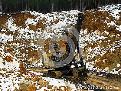 17.03.2012, Russia, Sverdlovsk region, Toshim bauxite mine - Voronezh crawler track excavator at the bottom of the Editorial Stock Photo