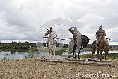 Russia, village Irbeyskoye, July 2019: sculpture Russian knights on the river Bank. hero of Russian epic Editorial Stock Photo