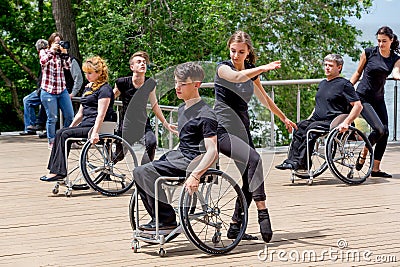 Russia, Vladivostok, 06/12/2018. Actors in wheelchairs and usual actors perform the dance on stage. Annual celebration Russia Day Editorial Stock Photo