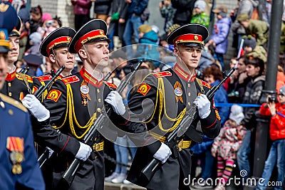 Russia, Vladivostok, 05/09/2018. Graduates of Suvorov Military School in dress uniform with machine guns on parade on annual Editorial Stock Photo