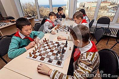 Russia, Vladivostok, 12/01/2018. Kids play chess during chess competition in chess club. Education, chess and mind games. Editorial Stock Photo