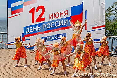 Russia, Vladivostok, 06/12/2018. Nice little girls in funny costumes perform the dance on stage. Celebration of annual Russia Day Editorial Stock Photo