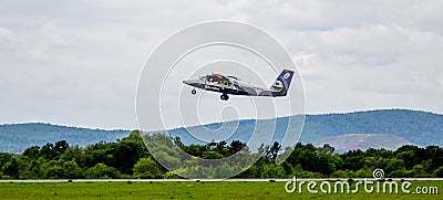 Passenger airplane De Havilland Canada DHC-6 of Aurora company takes off Editorial Stock Photo