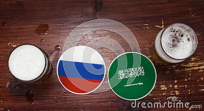 Russia Vs. Saudi Arabia Coasters at the bar with pints of beer. Stock Photo