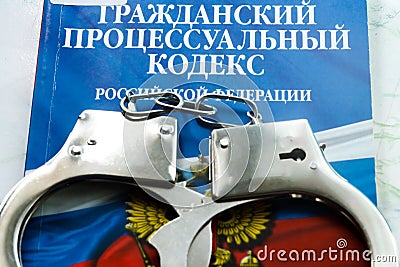 Russia. Vyborg 09.09.2021 handcuffs are on the Civil Code book. Inscription in Russian Civil Code Editorial Stock Photo