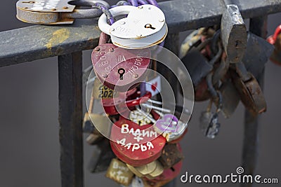 04.04.2021 Russia Vyborg locks in the shape of a heart attached to a metal hedge. symbol of eternal love Editorial Stock Photo