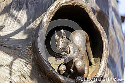 a bronze sculpture of a squirrel sitting in a hollow of a tree in the P.P. Bazhova on a summer day Editorial Stock Photo