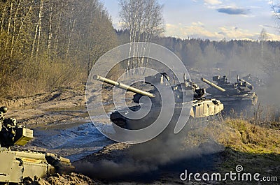 Russian armored combat vehicles are navigating through marshland through forests. Stock Photo