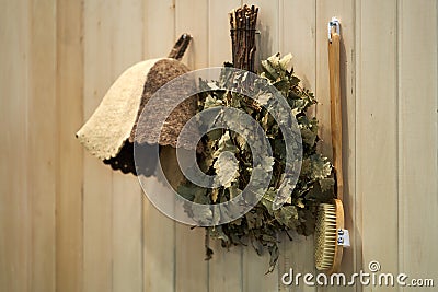 Russian bath accessories on wooden wall background, close-up Stock Photo