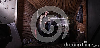 Russian car mechanic in a garage repairs the car Editorial Stock Photo