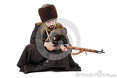 Russian Cossack inspecting a rifle. Stock Photo