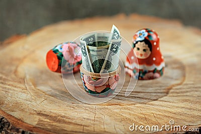 Russian doll with dollars inside. Anti crisis money box. Matrioska bank. Stock Photo