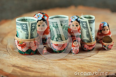 Russian doll with dollars inside. Anti crisis money box. Matrioska bank. Stock Photo