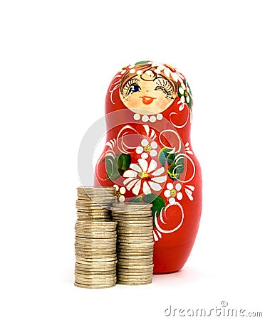 Russian Doll and Piles of Coins Stock Photo