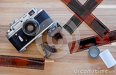 Russian Film Camera Zorki 4K with Kodak film and Lomography film and film sheet on wooden background Editorial Stock Photo