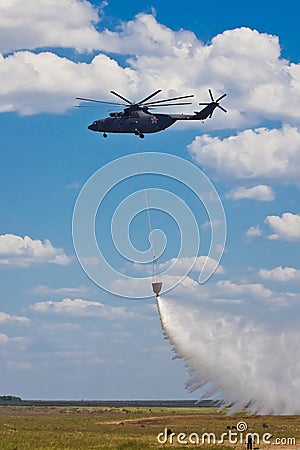 Russian firefighting helicopter with waterbag on fire extinguishing training Editorial Stock Photo