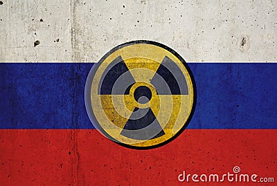 Russian flag on wall and radioactive symbol. Concept of nuclear weapons Stock Photo