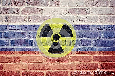 Russian flag on wall and radioactive symbol Stock Photo