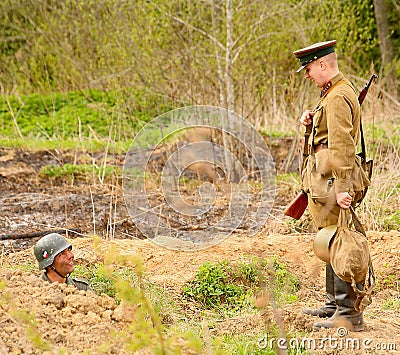 Russian and German soldiers. the reconstruction of the battle in military uniform of world war II. Editorial Stock Photo