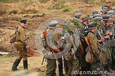 Russian and German soldiers. the reconstruction of the battle in military uniform of world war II. Editorial Stock Photo