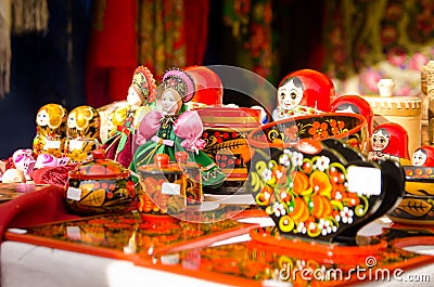 Russian home-made various souvenirs on sale at a city fair. nesting dolls and containers Editorial Stock Photo