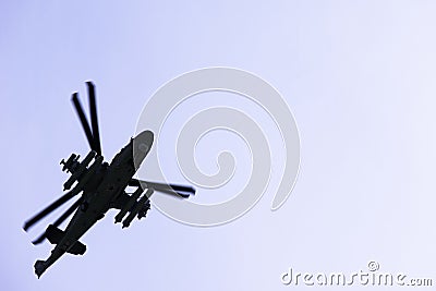 Russian military combat attack helicopter K-52 Alligator flies against a blue sky and clouds Stock Photo