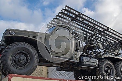 Russian multiple rocket launcher artillery BM-13 `Katyusha` mounted on soviet military truck on background of fence and cloudy sky Editorial Stock Photo