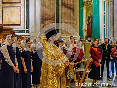 Russian Orthodox priest in traditional clothing serving in the Saint Isaac`s Russian Orthodox Cathedral in Saint Petersburg Russi Editorial Stock Photo