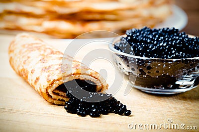 Russian pancakes - blini with black caviar. Shallow depth of fie Stock Photo