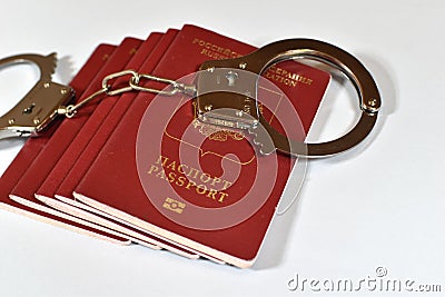 Russian passport and handcuffs on white background. prohibition of Russian citizens on entry and exit. passport lock Stock Photo