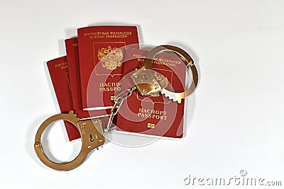 Russian passport and handcuffs on white background. prohibition of Russian citizens on entry and exit. passport lock Stock Photo