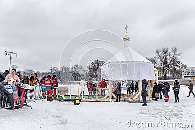 Russian people are dipped into an ice hole on the day of the Epiphany, St. Petersburg Editorial Stock Photo