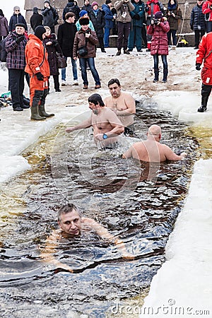 Russian people are dipped into an ice hole on the day of the Epiphany, St. Petersburg Editorial Stock Photo
