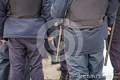 Russian police officer with black rubber tonfa baton hanging on his belt Stock Photo